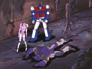 Arcee and Magnus standing next to a face-planted Galvatron